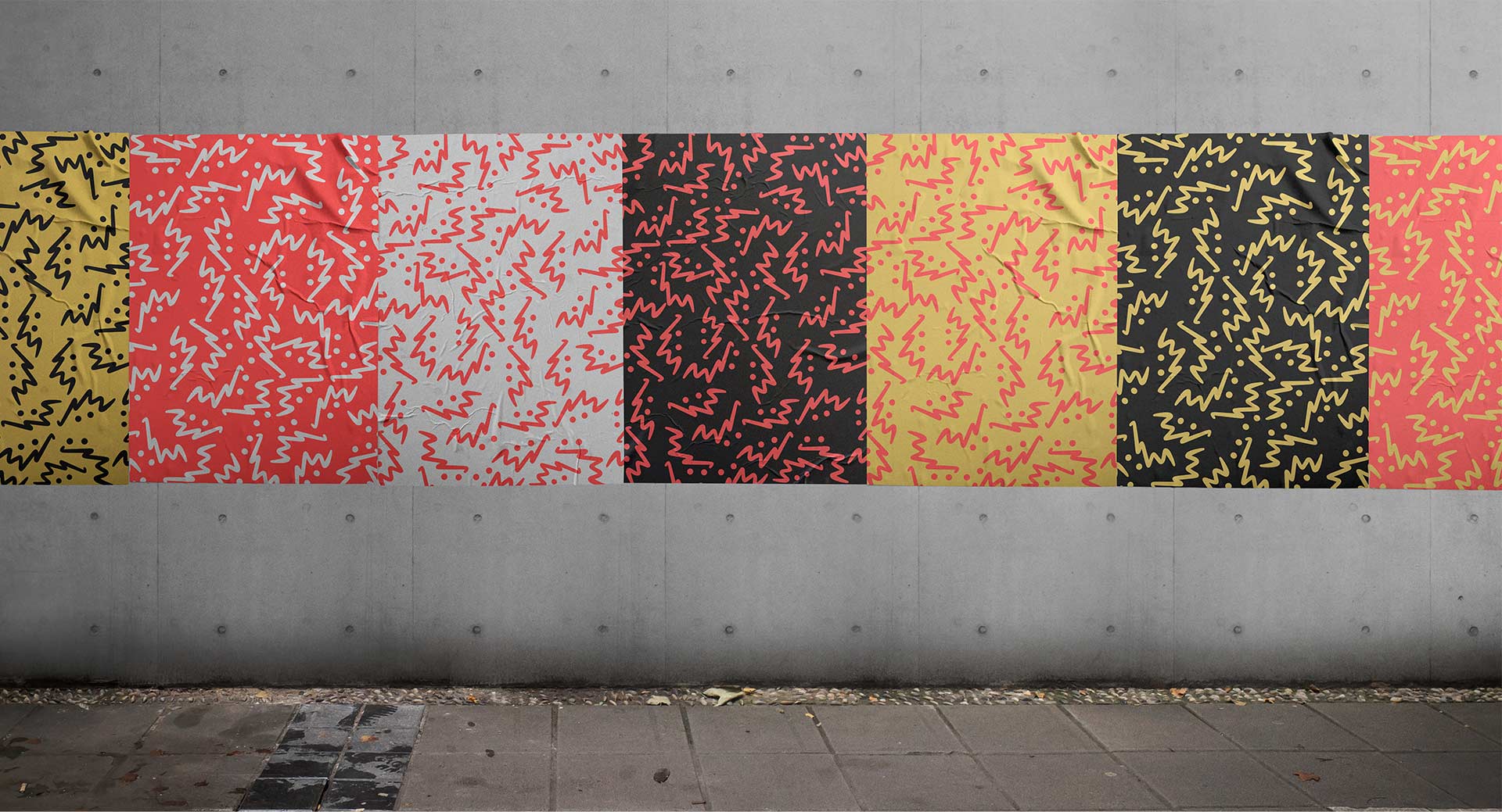 brand posters in multiple colors on concrete wall